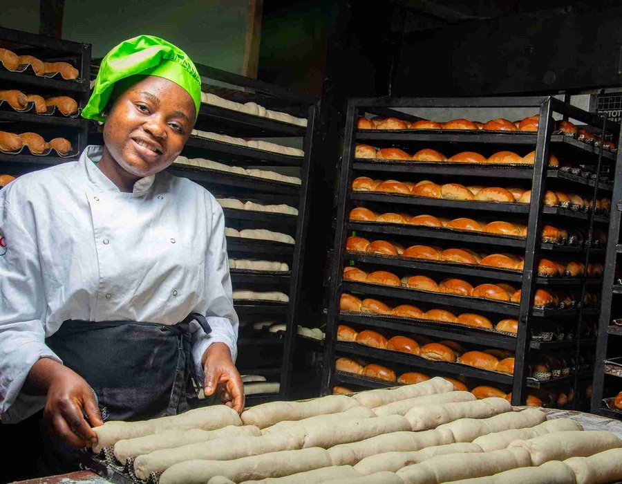 Baker shaping dough at the work table